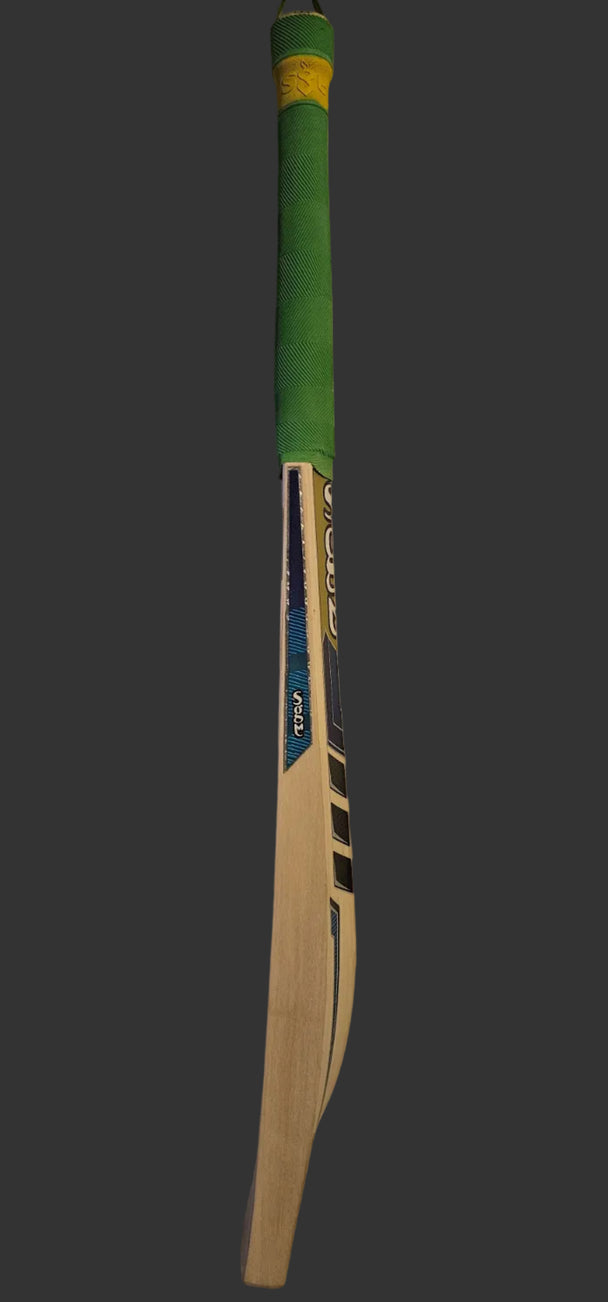 Cricket bat with green handle on a white surface